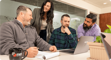 A group of people meet around a conference table